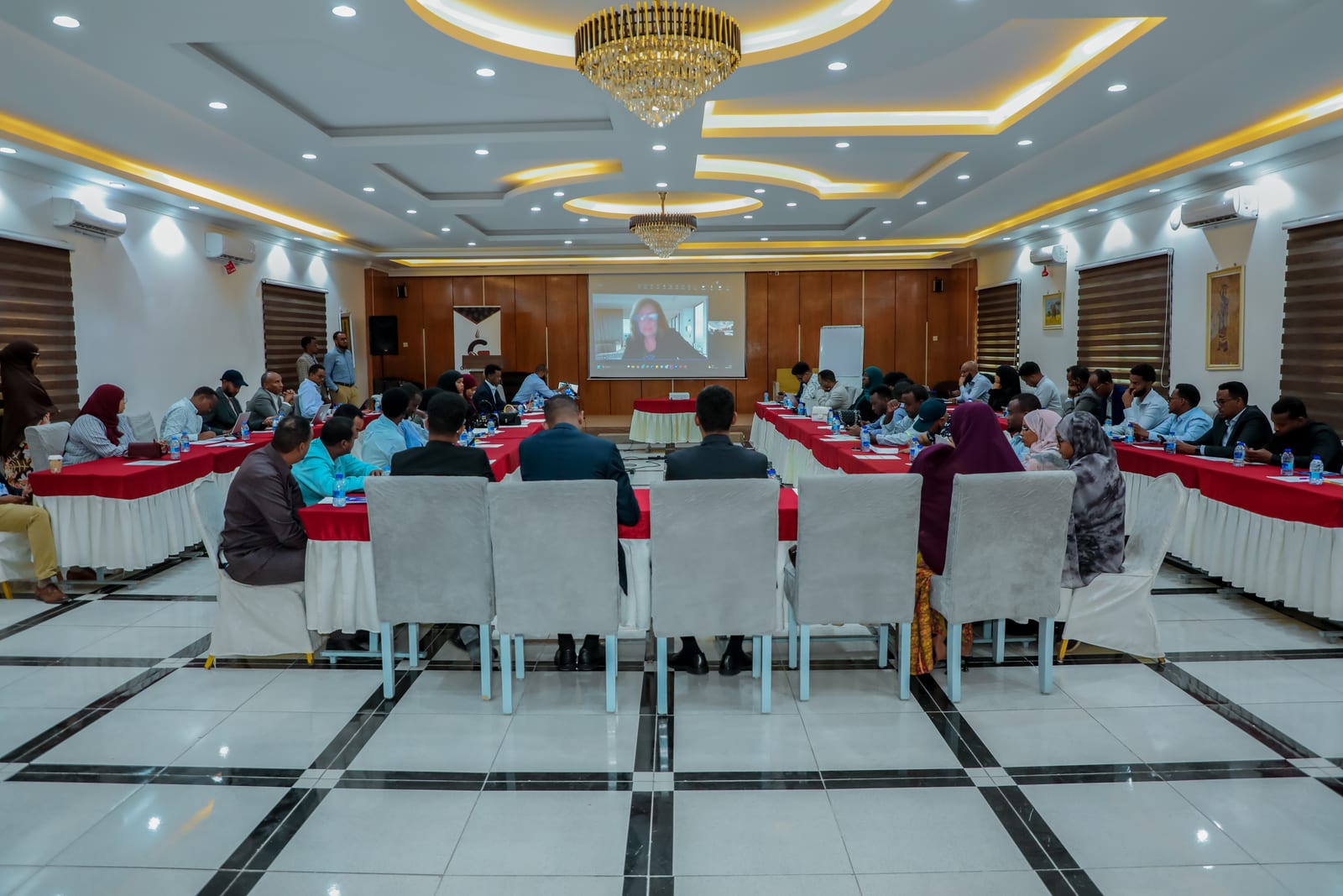 Government and business representatives seated around tables at the National Trade Policy validation workshop in Mogadishu